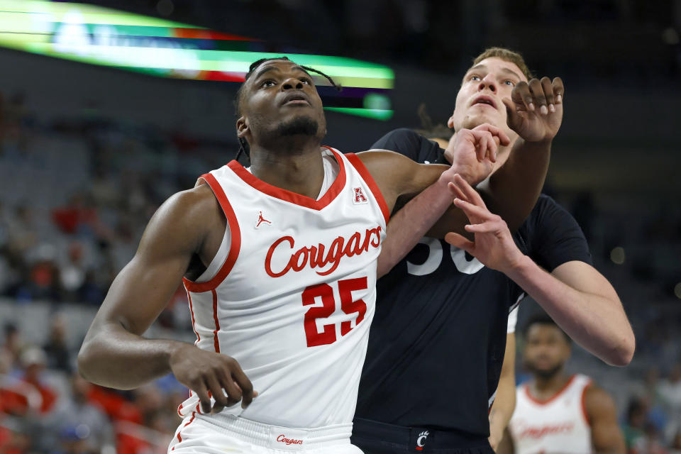 Houston forward Jarace Walker (25) fights for rebound position with Cincinnati forward Viktor Lakhin (30) during the second half of an NCAA college basketball game in the semifinals of the American Athletic Conference Tournament, Saturday, March 11, 2023, in Fort Worth, Texas. (AP Photo/Ron Jenkins)