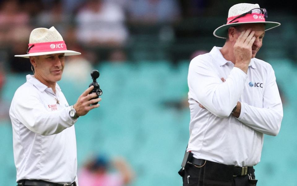 Even the umpires look fed up as the weather and bad light take their toll - David Gray/AFP