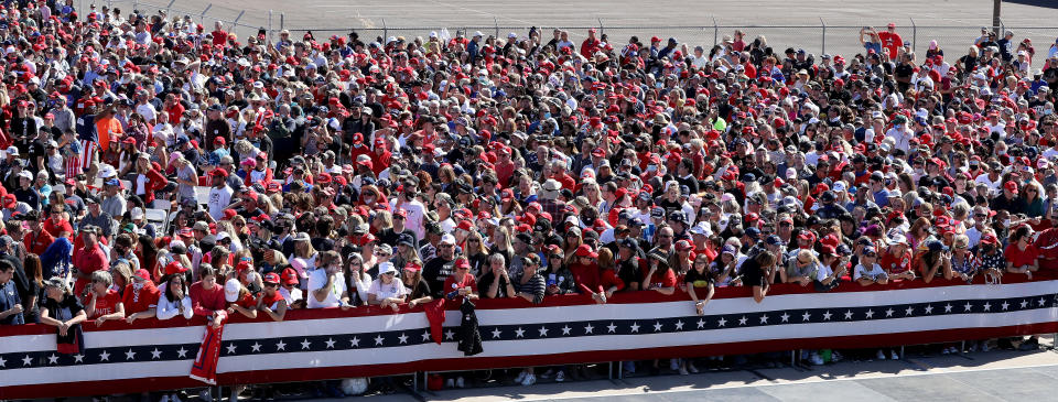 GOODYEAR, ARIZONA - OCTOBER 28: With few face masks and no social distancing to reduce the risk posed by the coronavirus, supporters wait for the arrival of U.S. President Donald Trump during a campaign rally at Phoenix Goodyear Airport October 28, 2020 in Goodyear, Arizona. With less than a week until Election Day, Trump and his opponent, Democratic presidential nominee Joe Biden, are campaigning across the country. (Photo by Chip Somodevilla/Getty Images)