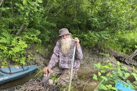 In this undated photo provided by Jodie Gedeon, David Lidstone, 81, smiles in the woods of Canterbury, N.H. Lidstone has lived in the woods along the Merrimack River for nearly three decades in a shack, growing his own food and cutting his firewood. He's now jailed after not complying with a court order to leave, and there's a growing petition to just let "River Dave" live out his days off the grid. (Jodie Gedeon via AP)