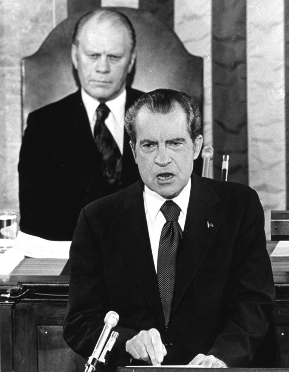 President Richard Nixon, with Vice President Gerald Ford behind him, delivers a State of the Union message to a joint session of Congress in 1974.