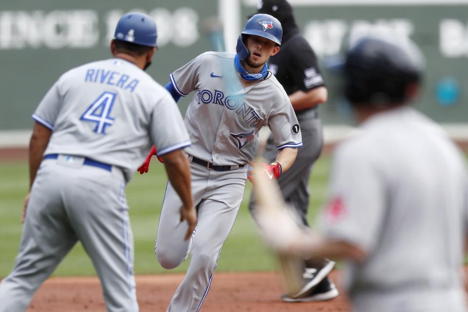 Toronto Blue Jays' Cavan Biggio, center, rounds third base on his solo home run during the third inning of a baseball game against the Boston Red Sox, Sunday, Aug. 9, 2020, in Boston. (AP Photo/Michael Dwyer)