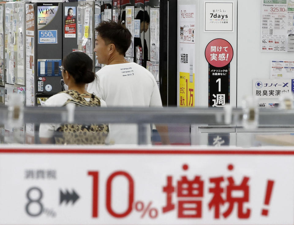 FILE - In this Sept. 30, 2019, file photo, a signboard says "Consumption tax hike, 8 percent to 10 percent", at a mass home electronics retailer in Tokyo. Japan reports on Thursday, Nov. 14, 2019 its economy grew at an annual pace of 0.2% in July-September, supported by consumer purchases ahead of a tax hike. (Shinji Kita/Kyodo News via AP, File)