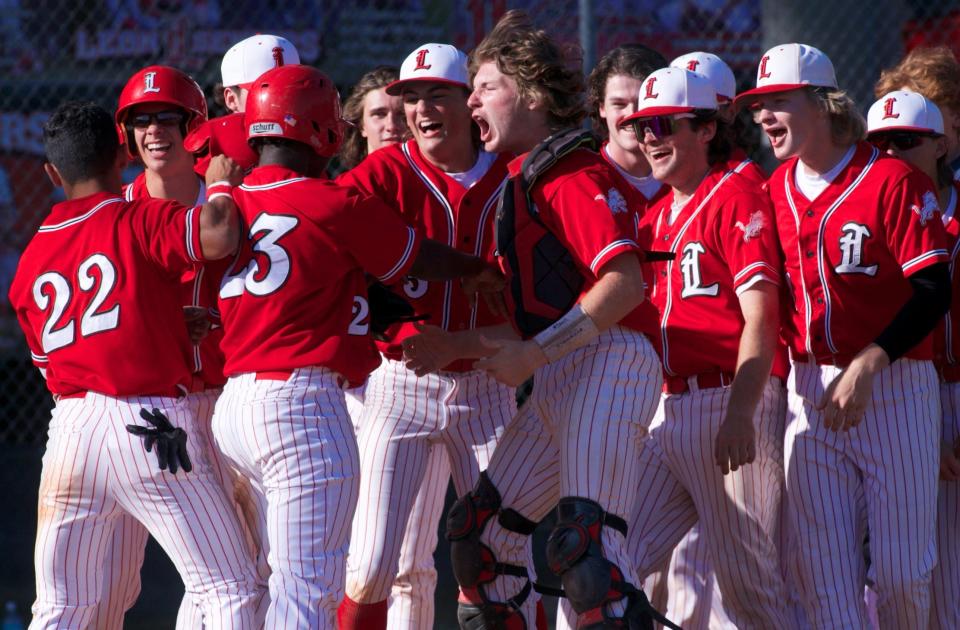 Leon players celebrate with sophomore Jay Campbell (23) after he hit a home run in a game against Chiles on April 4, 2022, at Leon High School. The Lions won 5-0.