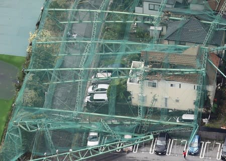 Houses and cars damaged by a collapse of the perimeter netting of a golf training field due to strong winds of Typhoon Faxai are seen in Ichihara