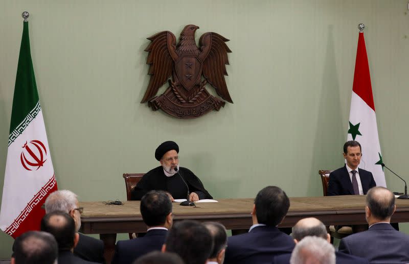 Syria's President Bashar al-Assad and Iranian President Ebrahim Raisi attend a press conference in Damascus