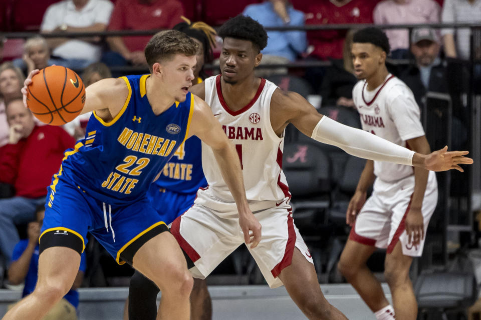 Morehead State guard Riley Minix (22) works against Alabama forward Mohamed Wague, front right, during the second half of an NCAA college basketball game, Monday, Nov. 6, 2023, in Tuscaloosa, Ala. (AP Photo/Vasha Hunt)