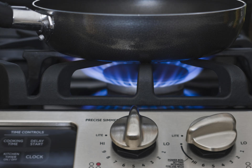 A skillet on a stove over heat.