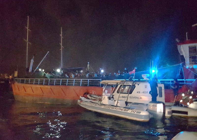 A Turkish Coast Guard Command boat is seen next to cargo ship during a raid in Izmir