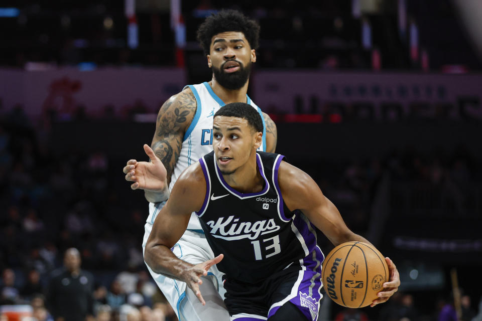 Sacramento Kings forward Keegan Murray (13) drives past Charlotte Hornets center Nick Richards during the second half of an NBA basketball game in Charlotte, N.C., Wednesday, Jan. 10, 2024. (AP Photo/Nell Redmond)