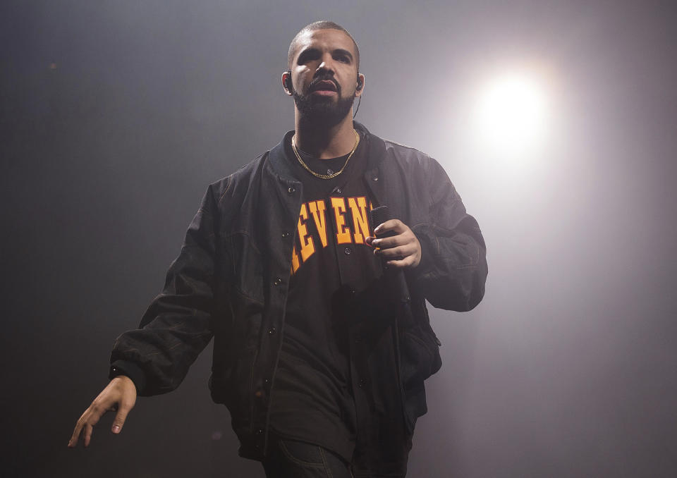 FILE - In this Aug. 5, 2016, file photo, Drake performs in concert as part of the Summer Sixteen Tour in New York. Photos and videos posted online Dec. 30, 2016 of Drake dancing with and kissing Jennifer Lopez has prompted internet speculation of a duet or romance between the two. (Photo by John Shearer/Invision/AP, File)(Photo by Charles Sykes/Invision/AP, File)