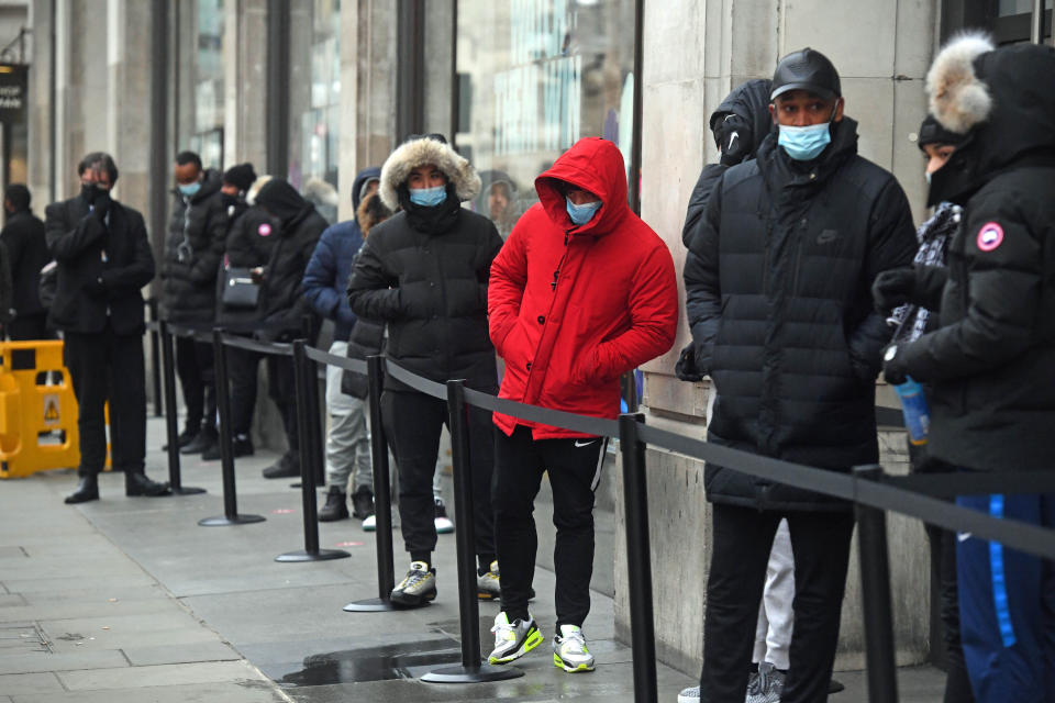 People queueing outside the Nike Town store at Oxford Circus, London, as non-essential shops in England open their doors to customers for the first time after the second national lockdown ends and England has a strengthened tiered system of regional coronavirus restrictions.