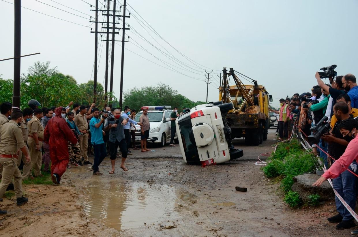 The overturned vehicle that was carrying top criminal Vikas Dubey is towed away near Kanpur, India, Friday, July 10, 2020. The top suspect in dozens of crimes, including the killings of eight police officers last week, was fatally shot Friday in police custody while allegedly trying to flee, officials said.