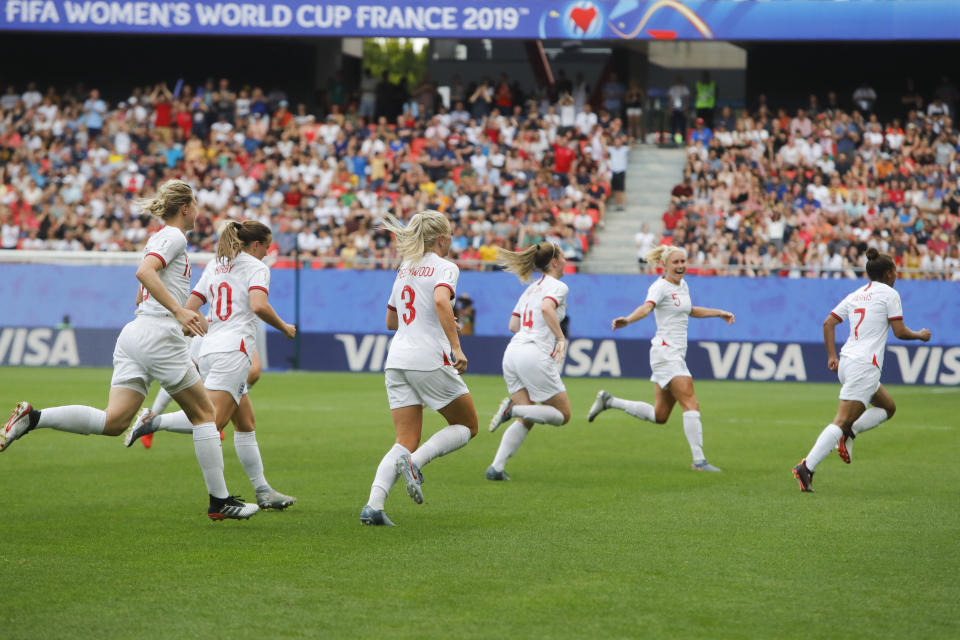 England's Alex Greenwood celebrates with her teammates after scoring her side's 3rd goal during the Women's World Cup round of 16 soccer match between England and Cameroon at the Stade du Hainaut stadium in Valenciennes, France, Sunday, June 23, 2019. (AP Photo/Michel Spingler)