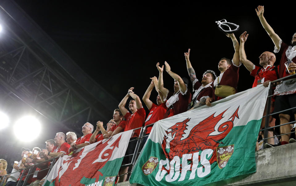 Welsh fans celebrate following the Rugby World Cup Pool D game between Wales and Georgia at Toyota City Stadium, Toyota City, Japan, Monday, Sept. 23, 2019.Wales defeated Georgia 43-14. (AP Photo/Christophe Ena)