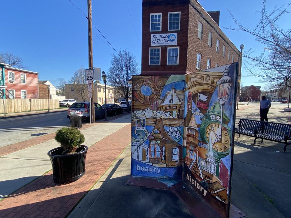 Landmarks from York's Latino history, all in one place: A mural depicts the Latino story in a block named for pioneers Edwin and Delma Rivera. Behind the mural, the second standalone Spanish American Center stands, now a bilingual church. In the background, the two-story white building served as the center for the Latino community in 2008 – Jose E. Hernandez Centro Hispano - and for about a decade afterward. All these landmarks stand in and around the South Queen Street neighborhoods where early Latinos settled in York.