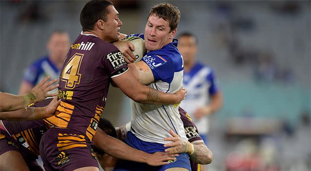 Bulldog Joshua Jackson is tackled by Roberts at ANZ Stadium. Photo: AAP