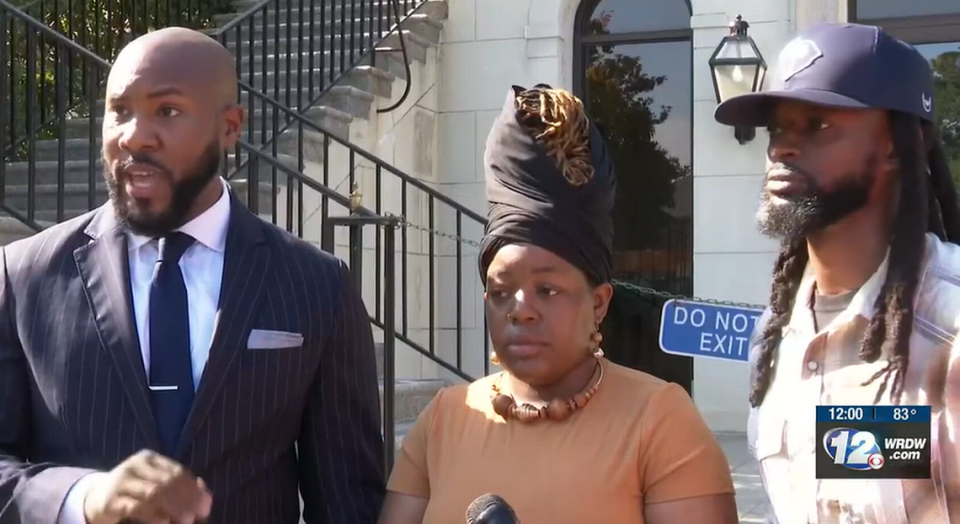 Tyler Bailey, Sylvia Brannon and her husband at the Sept. 12 news conference.