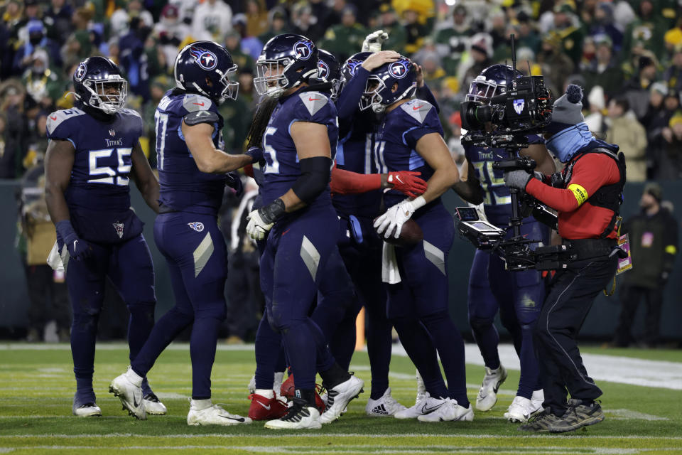 Tennessee Titans tight end Austin Hooper. center right, celebrates with teammates after catching a touchdown pass thrown by running back Derrick Henry during the second half of an NFL football game against the Green Bay Packers Thursday, Nov. 17, 2022, in Green Bay, Wis. (AP Photo/Matt Ludtke)