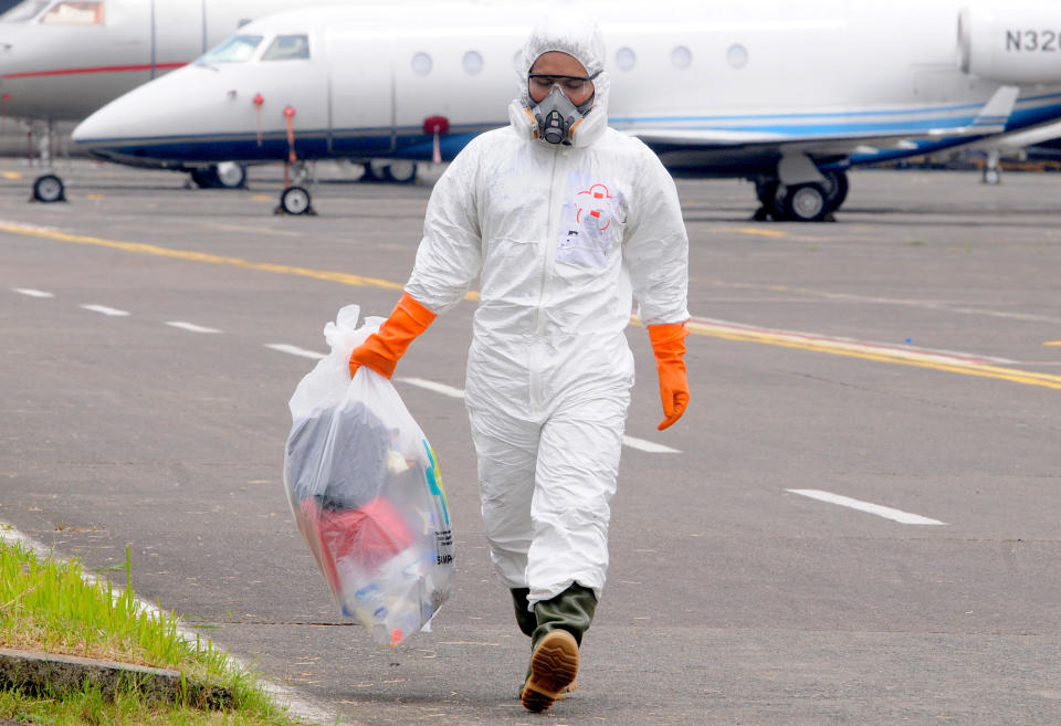 Officers wear hazmat or Corona anti-virus clothes when medical devices arrive from China on the Indonesian air force base Halim Perdanakusuma in Jakarta, Indonesia on March, 23, 2020. When the Corona Virus began to appear (covid-19) anti-virus clothing began to be difficult to obtain by the hospital or someone close to treating the patient because it was only worn once and had to be destroyed. Hazmat clothing is usually used by emergency medical technicians, paramedics, researchers, officers reacting to leakage of hazardous materials, experts who clean contaminated areas, and workers in toxic environments.  (Photo by Dasril Roszandi/NurPhoto via Getty Images)