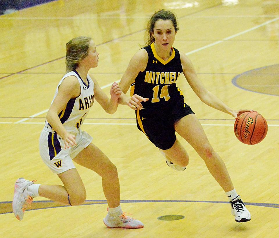 Mitchell's Sawyer Stoebner (14) drives to the hoop during a high school girls basketball game against Watertown during the 2021-22 season.