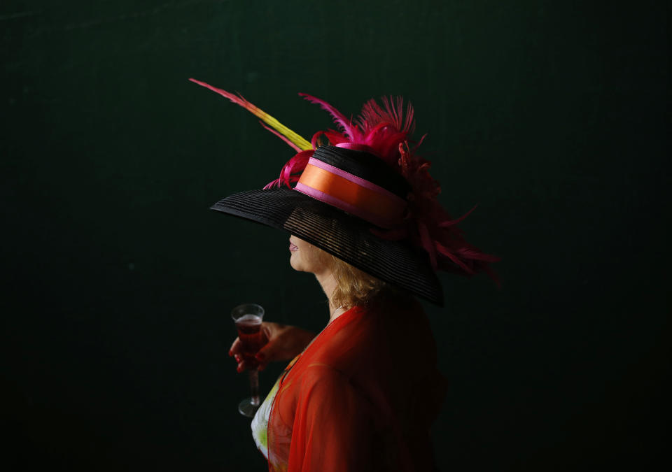 A woman makes her way to the track before the 140th running of the Kentucky Derby horse race at Churchill Downs Saturday, May 3, 2014, in Louisville, Ky. (AP Photo/Matt Slocum)