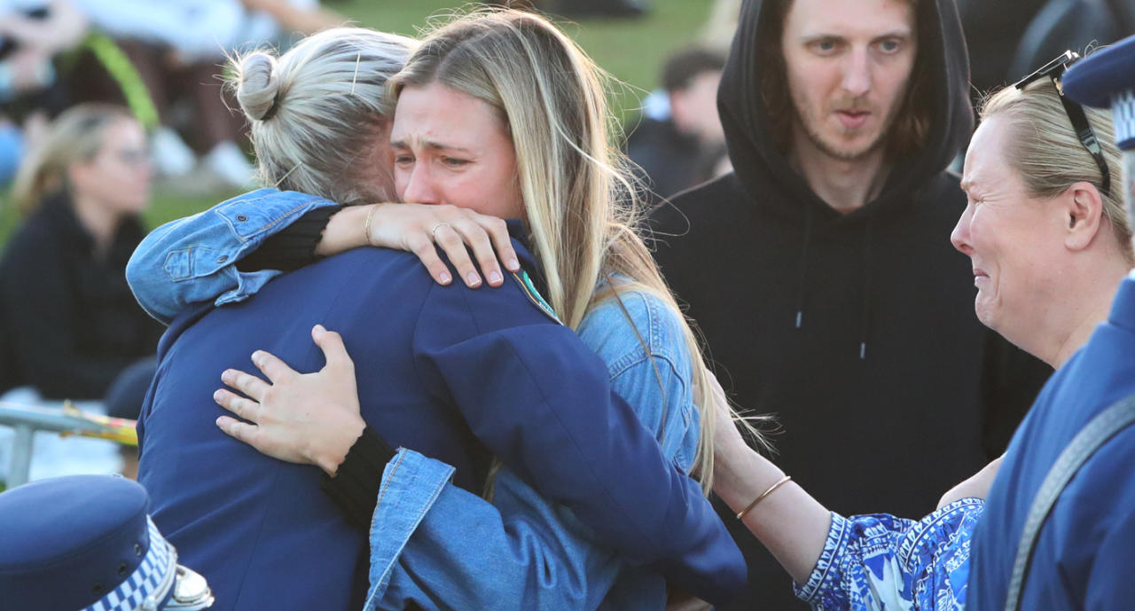 Amy Scott embraced emotional attendees at the vigil. Source: Getty