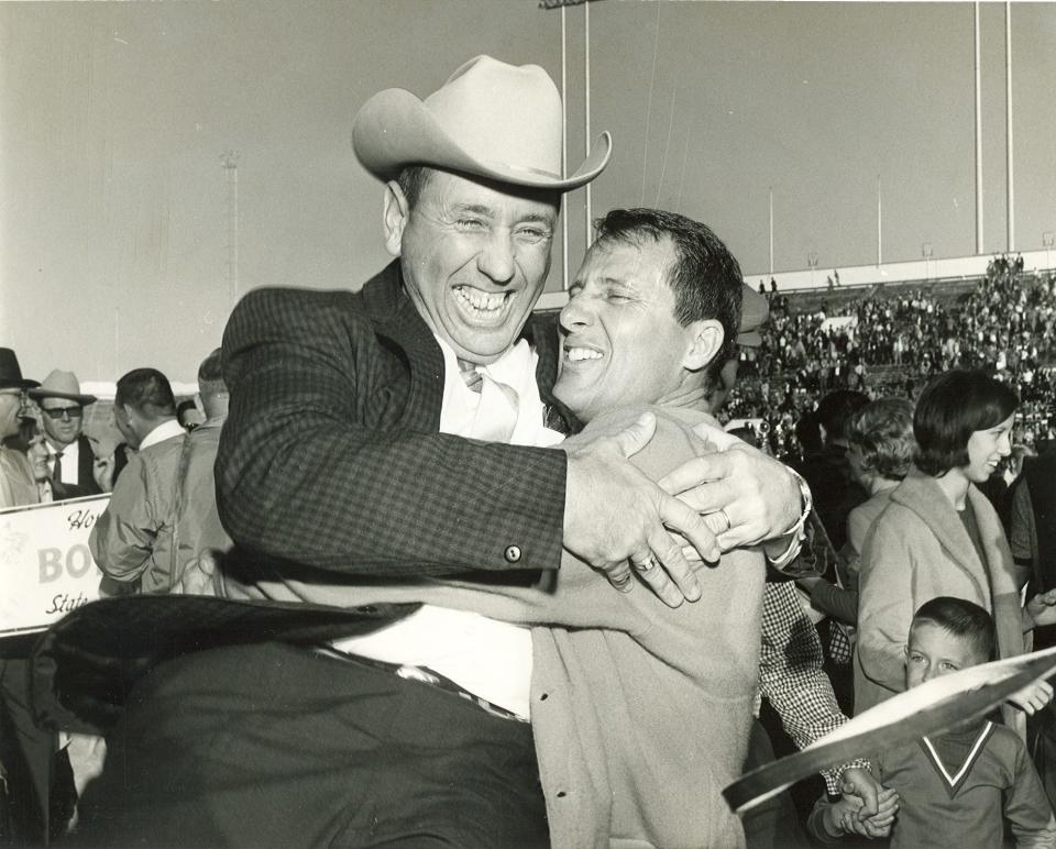 San Angelo Central football coach Emory Bellard (right) hugs Mickey Rathbone after the Bobcats won the state title in football in 1966.