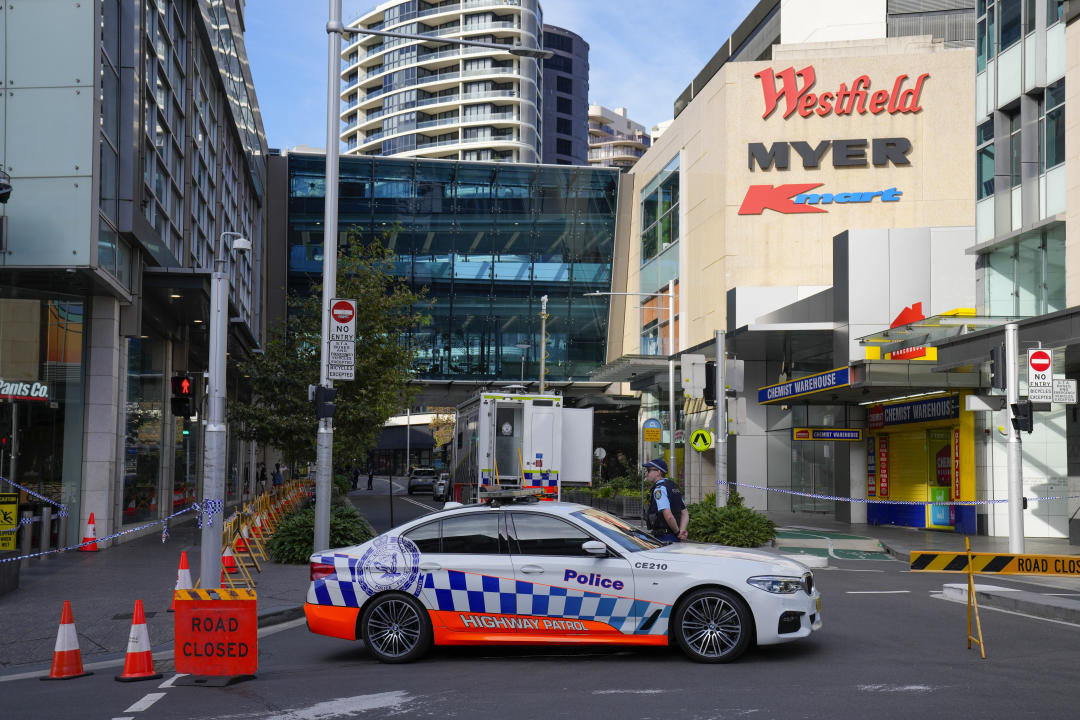 A police officer stands at police cordon near a crime scene at Bondi Junction in Sydney, Monday, April 15, 2024, after several people were stabbed to death at a shopping, Saturday April 13. Australian police are examining why a lone assailant who stabbed multiple people to death in a busy Sydney shopping mall and injured more than a dozen others targeted women while avoiding men. (AP Photo/Mark Baker)