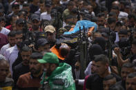 Palestinian mourners, some armed, carry the body of Amjad al-Fayyed, 17, during his funeral in the West Bank refugee camp of Jenin, Saturday, May 21, 2022. Israeli troops shot and killed al-Fayyed as fighting erupted when soldiers entered a volatile town in the occupied West Bank early Saturday, the Palestinian health ministry and local media said. (AP Photo/Majdi Mohammed)