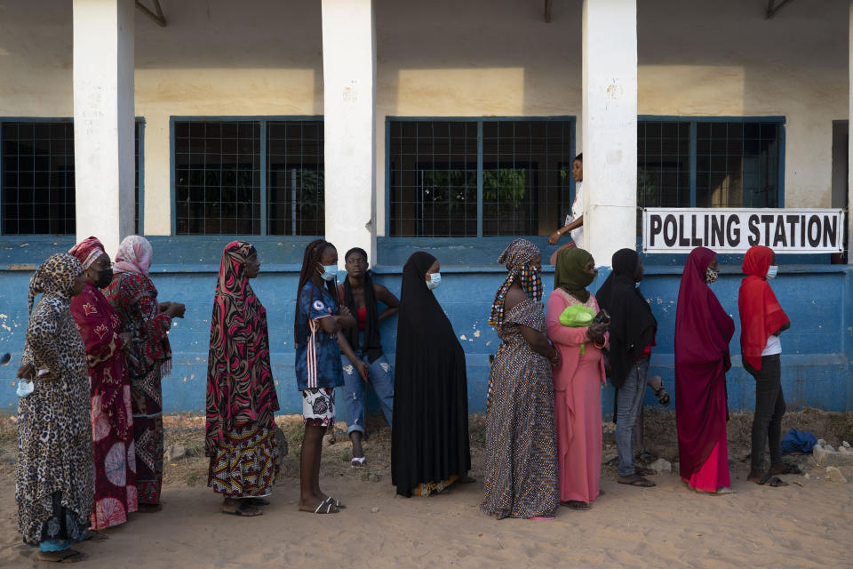 People line up to cast their ballot for Gambia's presidential elections in Bakau, Gambia, Saturday, Dec. 4, 2021. Gambians vote in a historic election that will for the first time not have former dictator Yahya Jammeh, who ruled for 22 years, on the ballot. (AP Photo/Leo Correa)