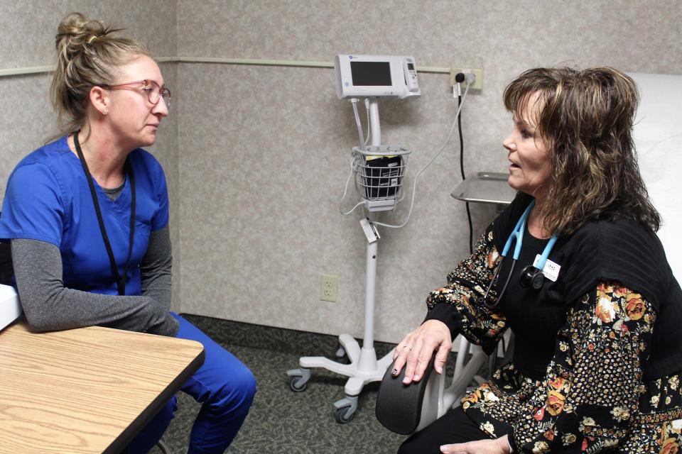 Nurse Practitioner Rose Picchi (right) consults with medical assistant Shawn Hengst in one of the Indian Family Health Clinic's newly remodeled examination rooms.