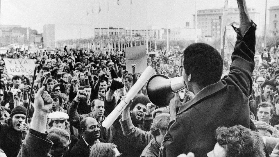 A Black Students Union leader rallies a crowd of demonstrators at San Francisco State College in December 1968. The union had gone on strike after racial strife between students and administration. - AP
