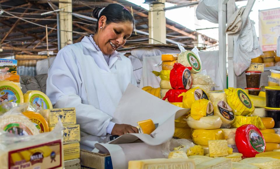 A woman at a cheese stall in Cuzco's Mercado Central de San Pedro.