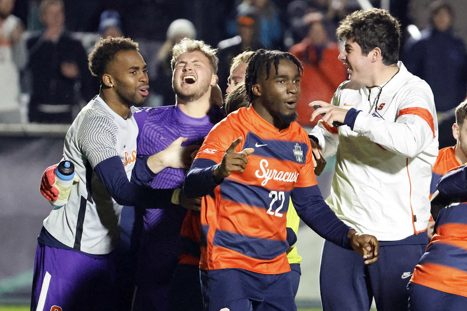 Syracuse players celebrate after winning the NCAA college soccer tournament final against Indiana in Cary, N.C., Monday, Dec. 12, 2022. (AP Photo/Karl B DeBlaker)