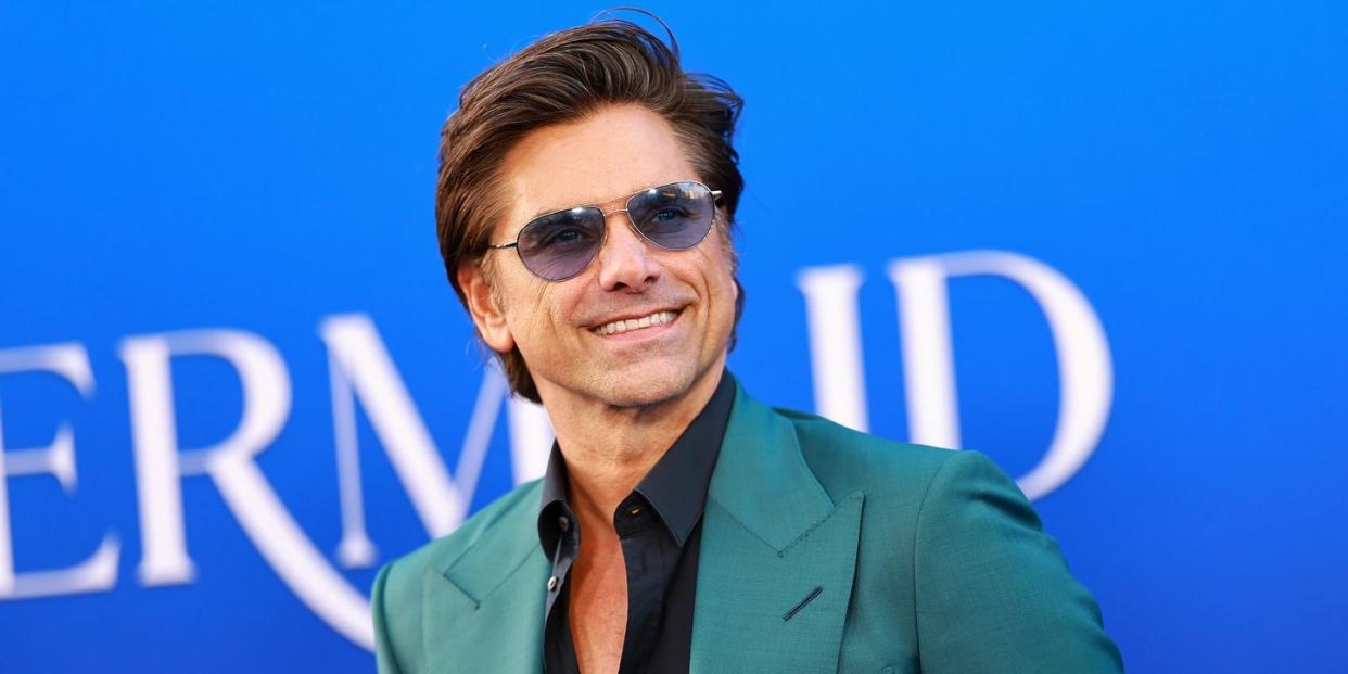 john stamos attends the world premiere of disneys the little mermaid
