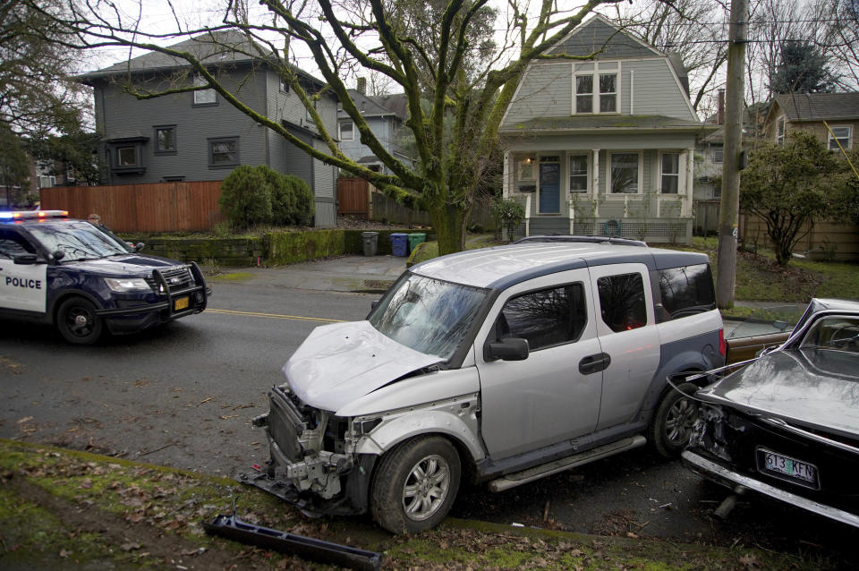 Wrecked vehicles are seen after a driver struck and injured at least five people over a 20-block stretch of Southeast Portland, Ore., before crashing and fleeing on Monday, Jan. 25, 2021, according to witnesses. (Beth Nakamura/The Oregonian via AP)