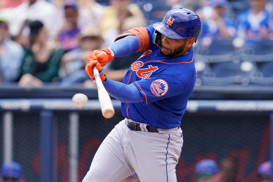 New York Mets' Dominic Smith singles in the second inning of a spring training baseball game against the Houston Astros, Monday, April 4, 2022, in West Palm Beach, Fla.