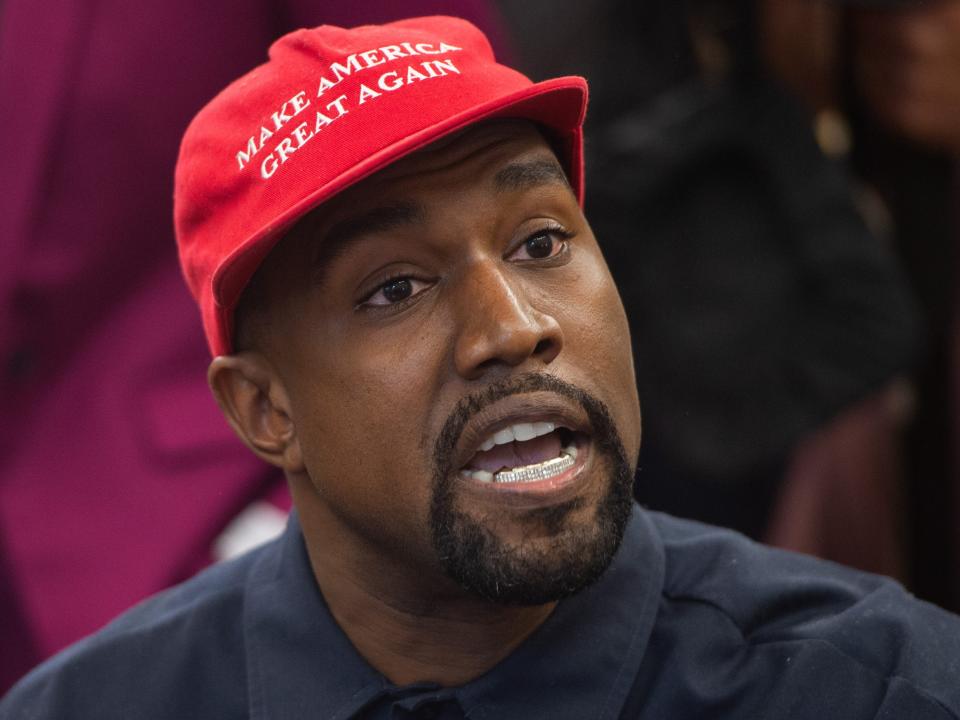 Kanye West in red MAGA Trump hat