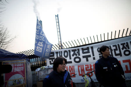 Shin Hyun-chang, a former GM Korea Bupyeong plant engine line worker and Hwang Ho-in, a forklift truck driver at the plant, stand outside the plant in Incheon, South Korea March 12, 2018. REUTERS/Kim Hong-Ji