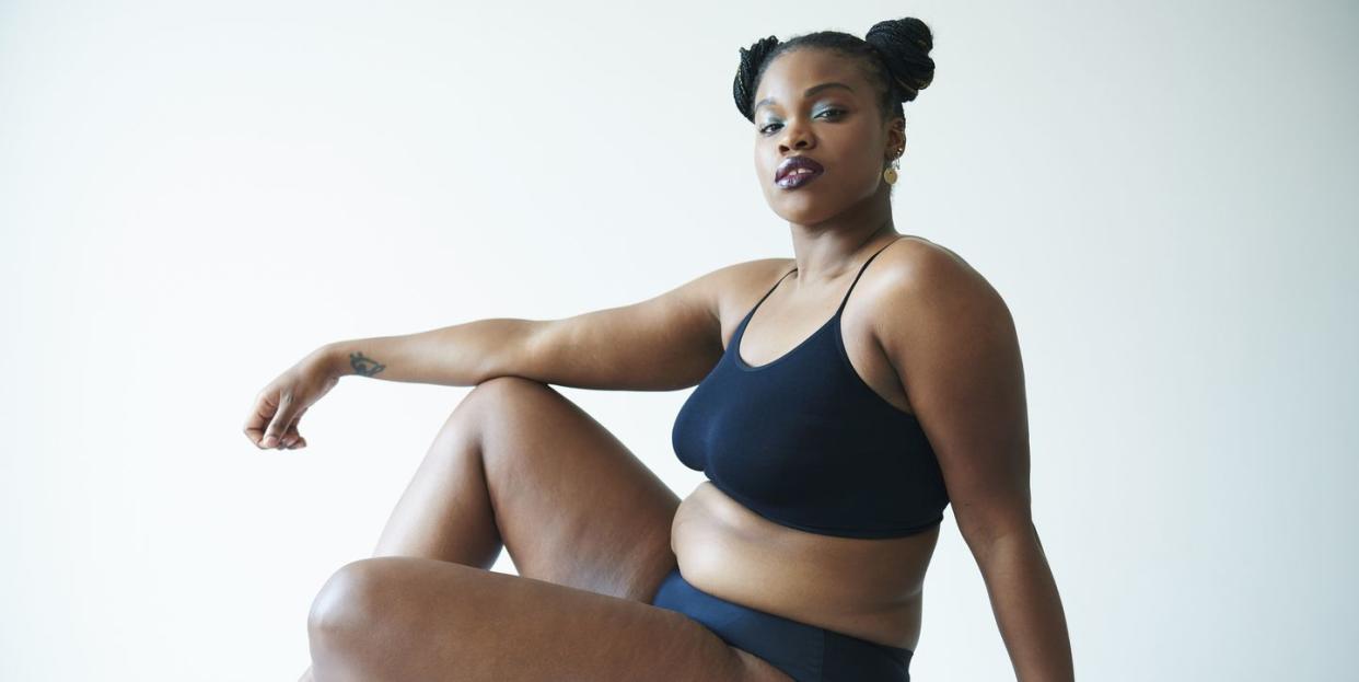 confident curvy woman sitting and looking to camera