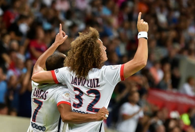 Paris Saint-Germain's midfielder Lucas Moura (L) celebrates with defender David Luiz after scoring during a French Ligue 1 football match against Lille on August 7, 2015 at the Pierre Mauroy Stadium in Villeneuve d'Ascq