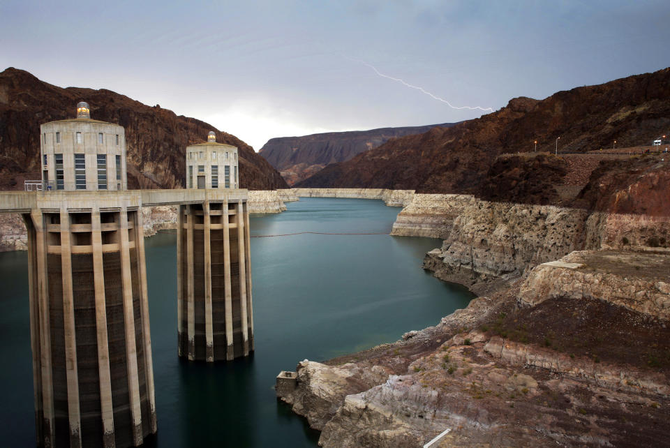 FILE - In this July 28, 2014, file photo, lightning strikes over Lake Mead near Hoover Dam that impounds Colorado River water at the Lake Mead National Recreation Area in Arizona. Water officials in Arizona say they are prepared to lose about one-fifth of the water the state gets from the Colorado River in what could be the first mandated cut. The federal government recently projected the first-ever shortage of river water that supplies millions of people in the U.S. West and Mexico. (AP Photo/John Locher, File)