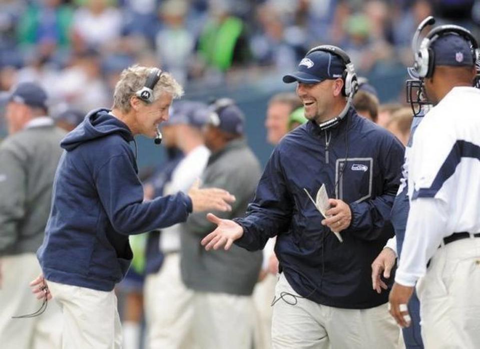 Enthusiastic Seattle Seahawks coach Pete Carroll, left, shook a lot of hands Sunday, Sept. 13, this time with defensive coordinator Gus Bradley during the third quarter against the 49ers. Seattle beat San Francisco, 31-6, in its season opener.