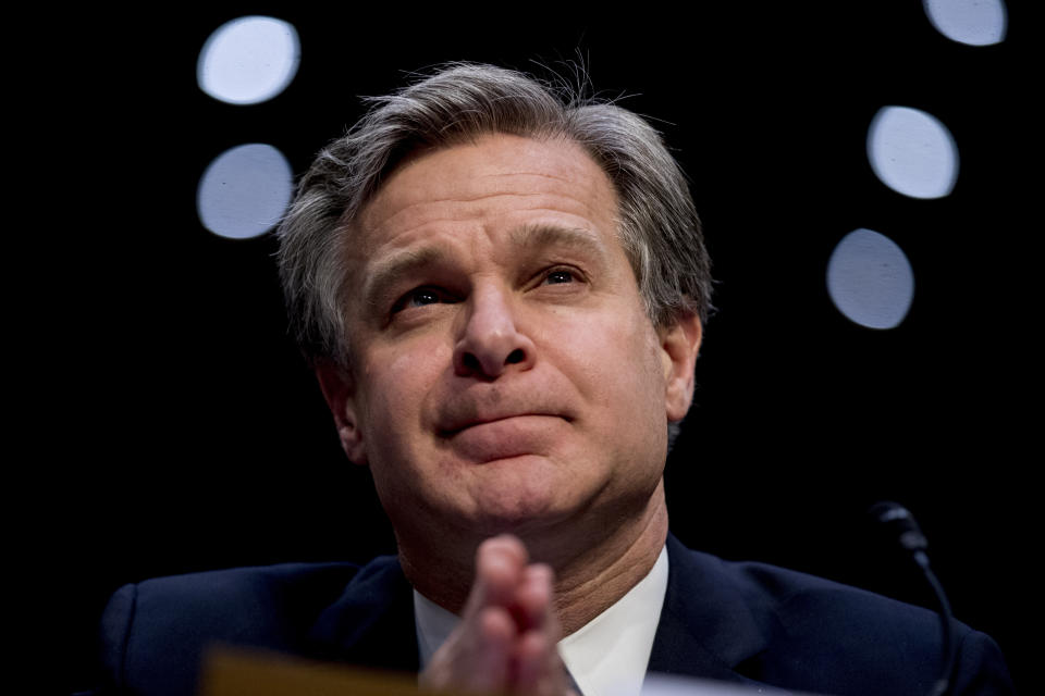 FILE - In this Nov. 5, 2019 file photo, FBI Director Christopher Wray pauses while testifying before a Senate Homeland Security Committee hearing on Capitol Hill in Washington. The FBI has found a link between the gunman in a deadly attack at a military base last December and an al-Qaida operative. That's according to a U.S. official who spoke to The Associated Press on Monday. (AP Photo/Andrew Harnik)