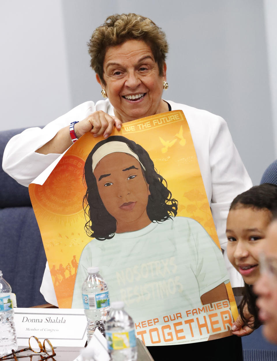 Rep. Donna Shalala, D-Fla., holds up a poster she received at a round table discussion with immigration advocates on the family separation policy, Tuesday, Feb. 19, 2019, in Miami. (AP Photo/Wilfredo Lee)