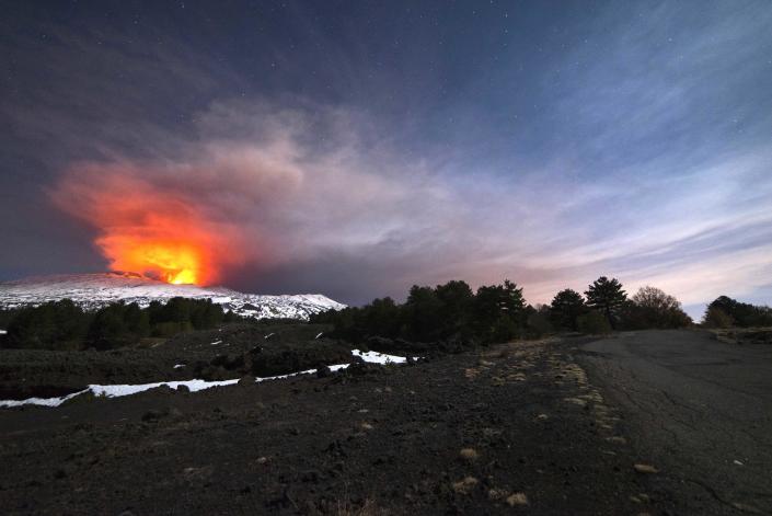 Mount Etna, Europe's most active volcano, is seen from the side of a road as it spews lava during an eruption in the early hours of Thursday, March 16, 2017. A new eruption which began on March 15 is causing no damages to Catania's airport which is fully operational. (AP Photo/Salvatore Allegra)