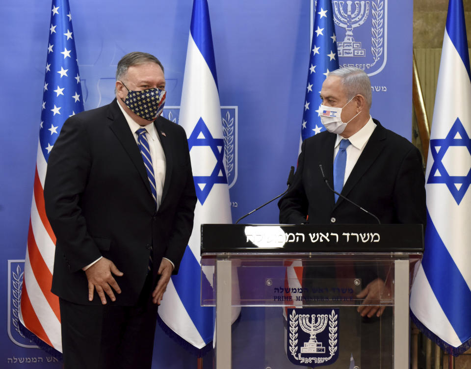 U.S. Secretary of State Mike Pompeo, left, and Israeli Prime Minister Benjamin Netanyahu wear face masks to help prevent the spread of the coronavirus after they make joint statements to the press, in Jerusalem, Monday, Aug. 24, 2020. (Debbie Hill/Pool via AP)