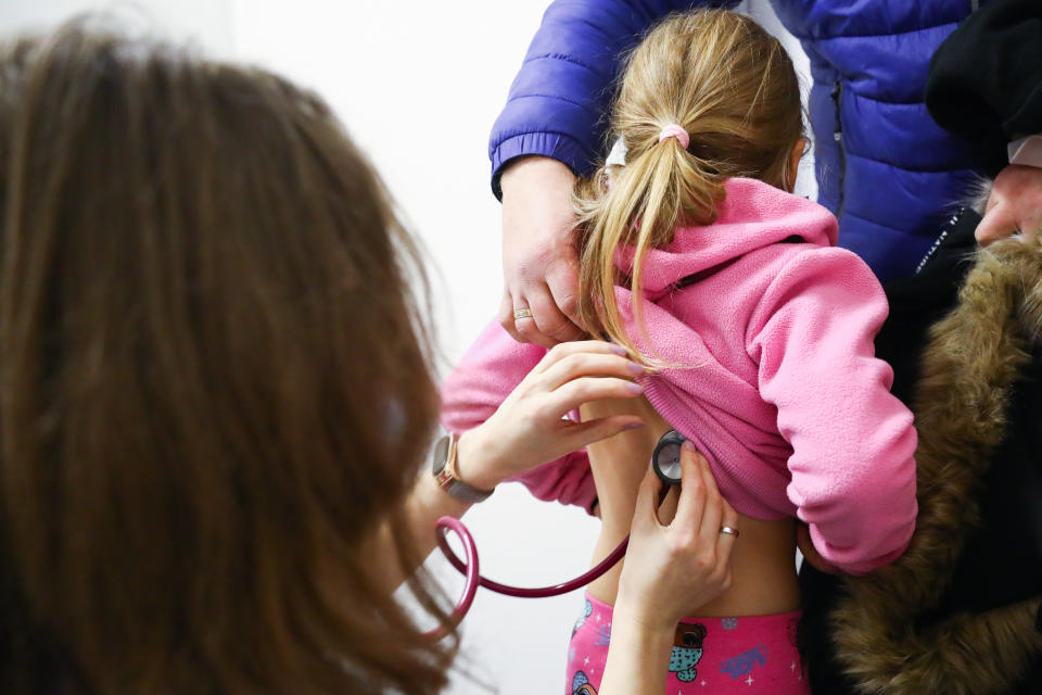 A health worker uses a stethoscope to examine a child.  (Photo by Beata Zawrzel/NurPhoto via Getty Images)