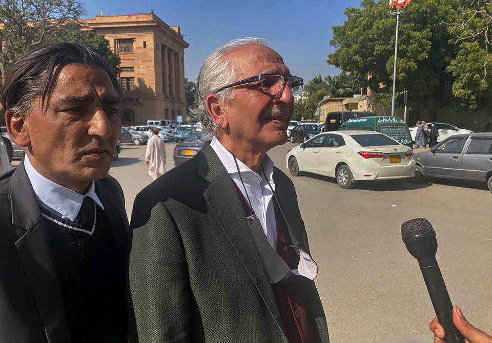 Mehmood A. Sheikh, center, a defense lawyer for British-born Pakistani Ahmed Omar Saeed Sheikh, Ahmed Omar Saeed Sheikh, who is charged in the 2002 murder of American journalist Daniel Pearl, talks to a journalists outside the Sindh High Court, in Karachi, Pakistan, Thursday, Dec. 24, 2020. The provincial court overturned a Supreme Court Decision that Sheikh should remain in custody during an appeal of his acquittal on charges he murdered Pearl. (AP Photo/Adil Jawad)